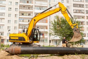 Using of excavator as crane for raising of pile 531738671 4256x2832